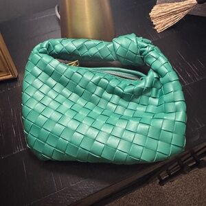 Woven green leather clutch